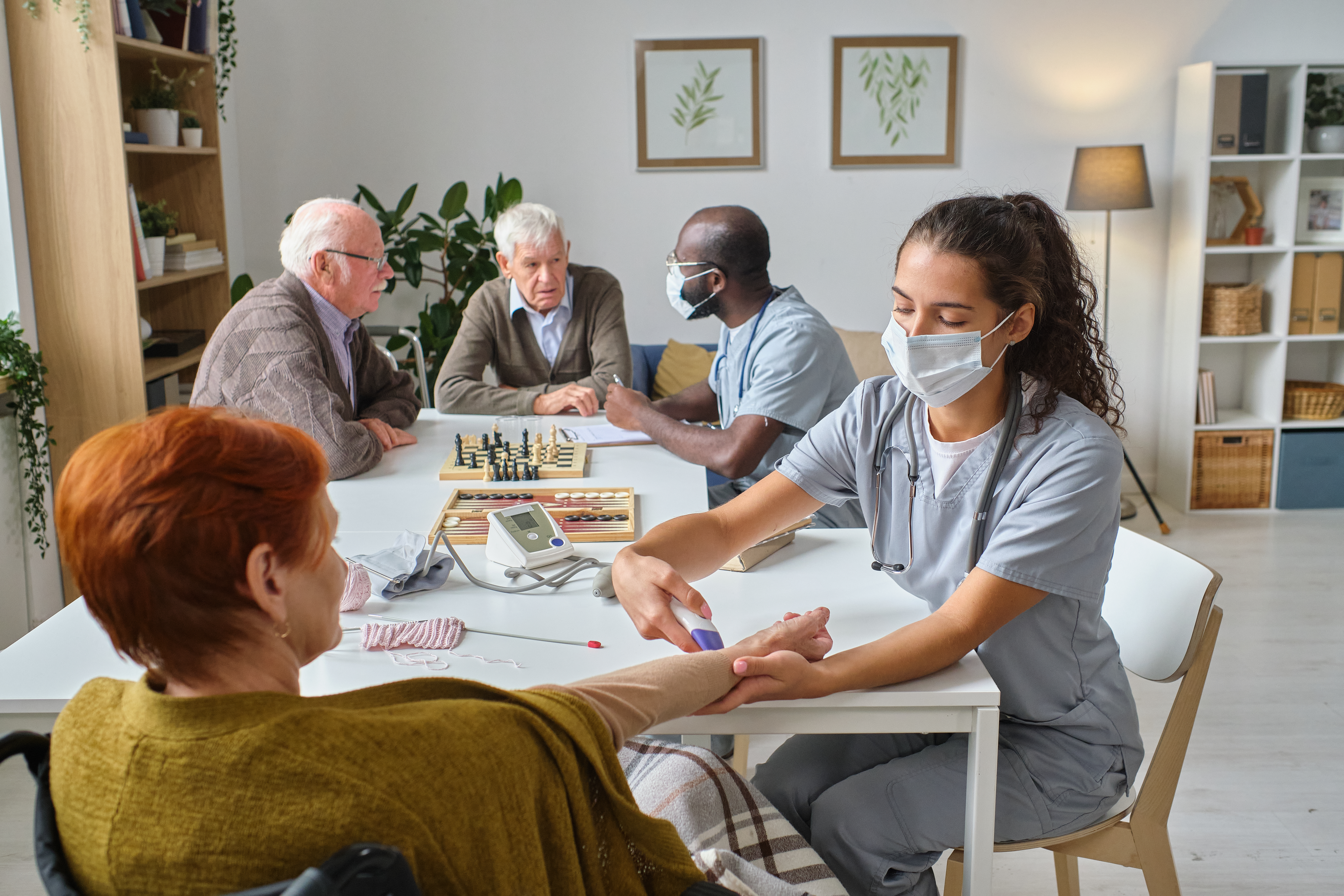 Caregiver supporting an older adult during a home health visit in Greenwood, Mississippi
